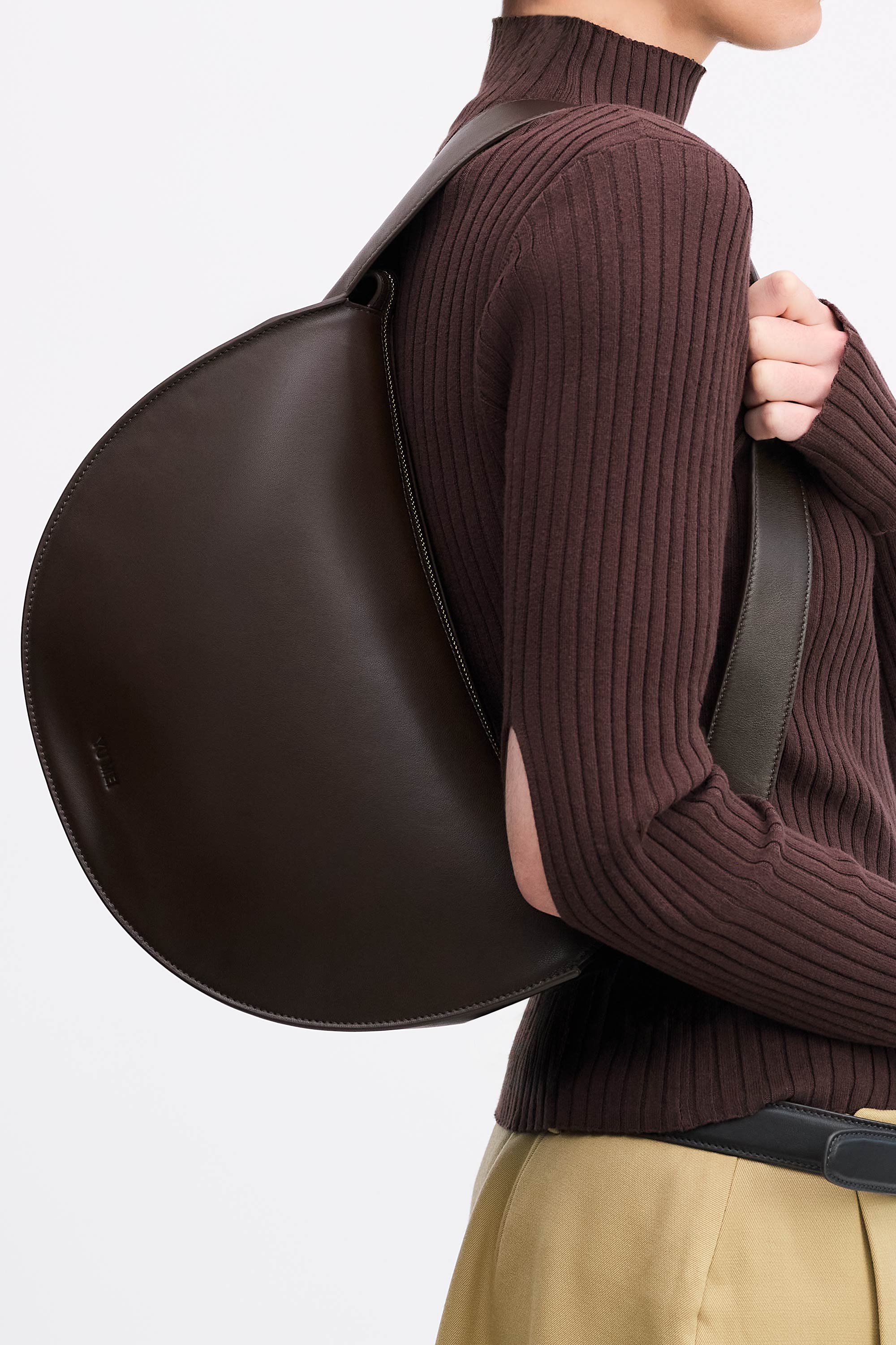 Antonia Bag in Molasses Lambskin worn on shoulder by model in brown top and tan skirt