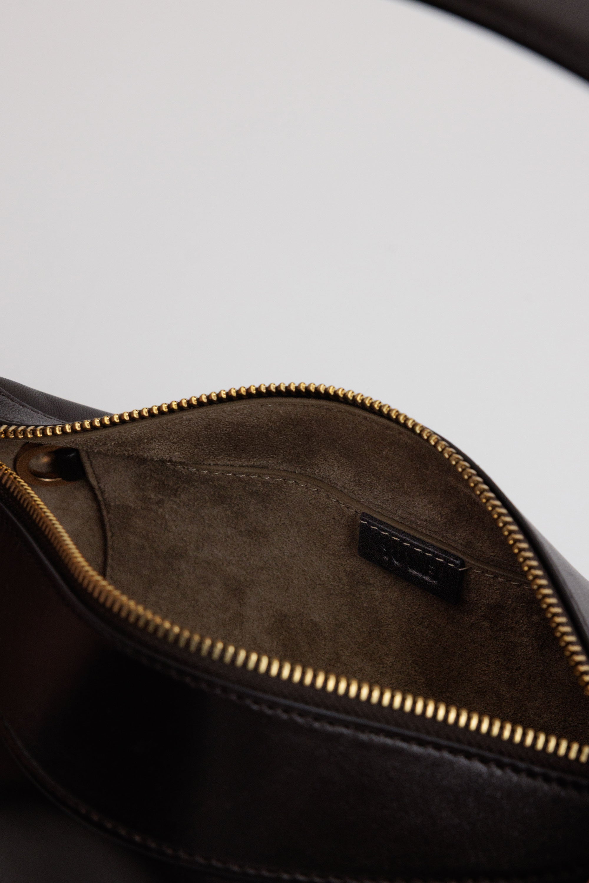 Bobby Bag in Americano Lambskin interior view showing small interior zip pocket and recycled suede lining