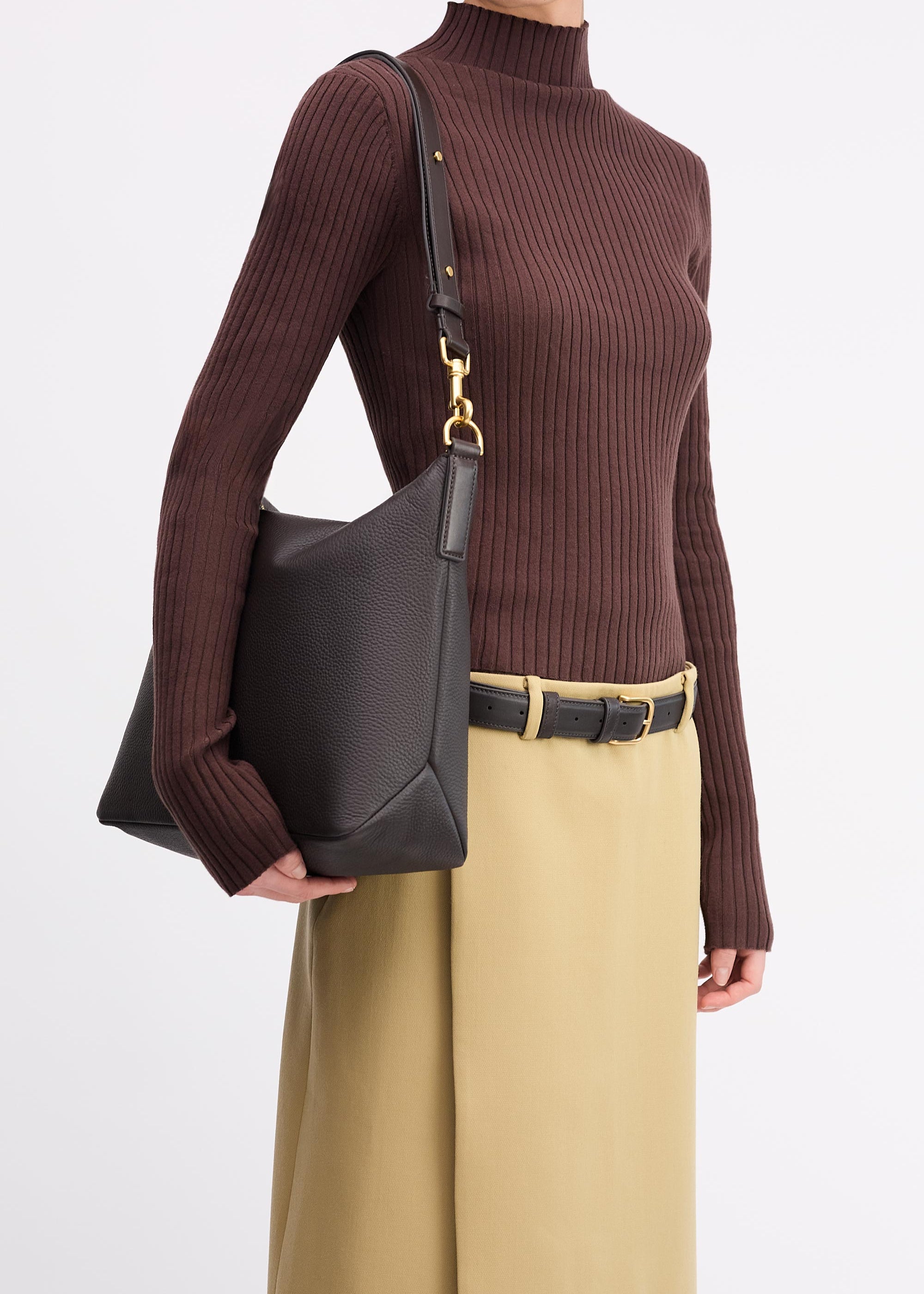 Braidy Bag in Americano Deer Nappa worn on shoulder of person wearing brown top and tan skirt