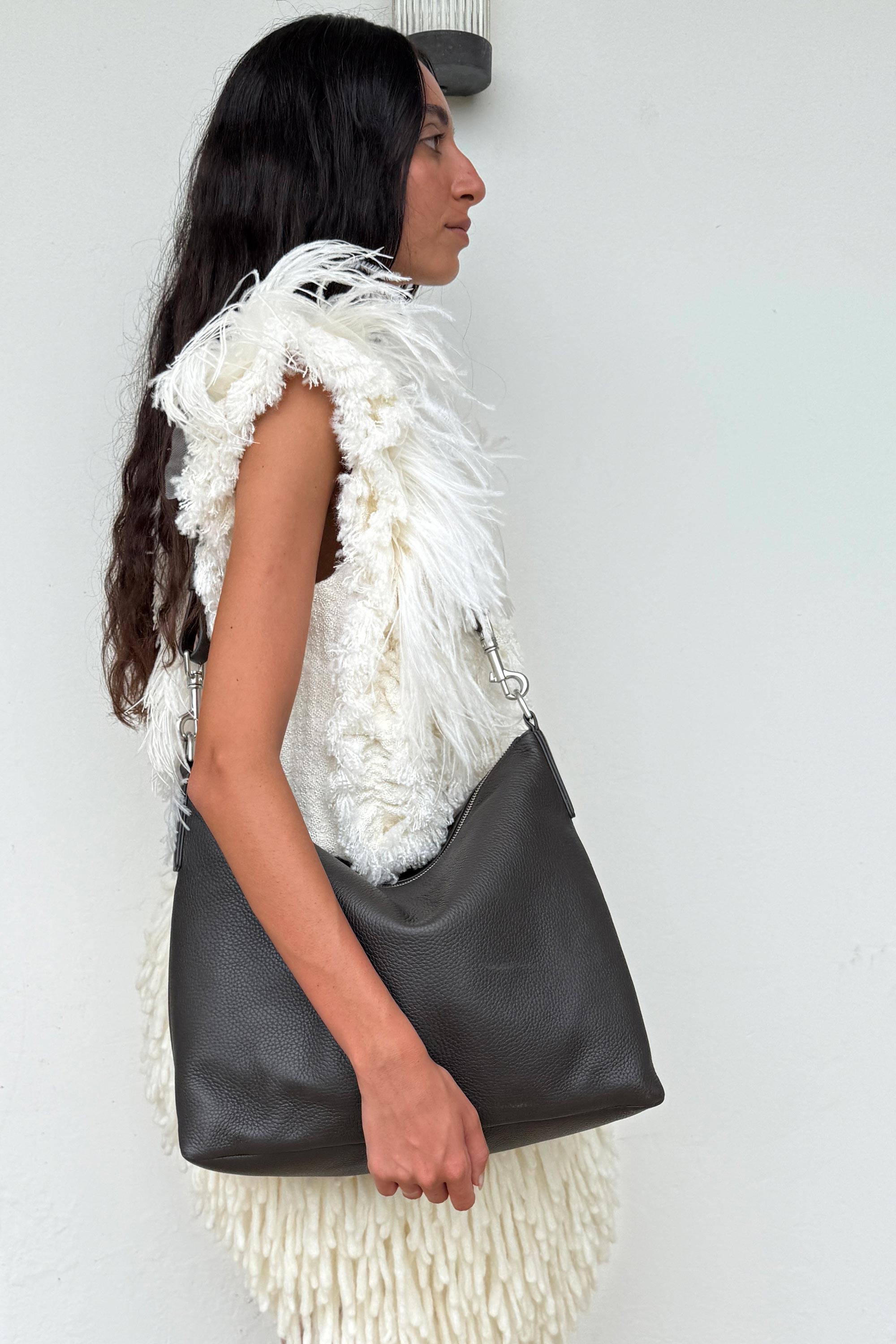 Model wearing the Braidy Bag in Black Olive deer nappa over shoulder
