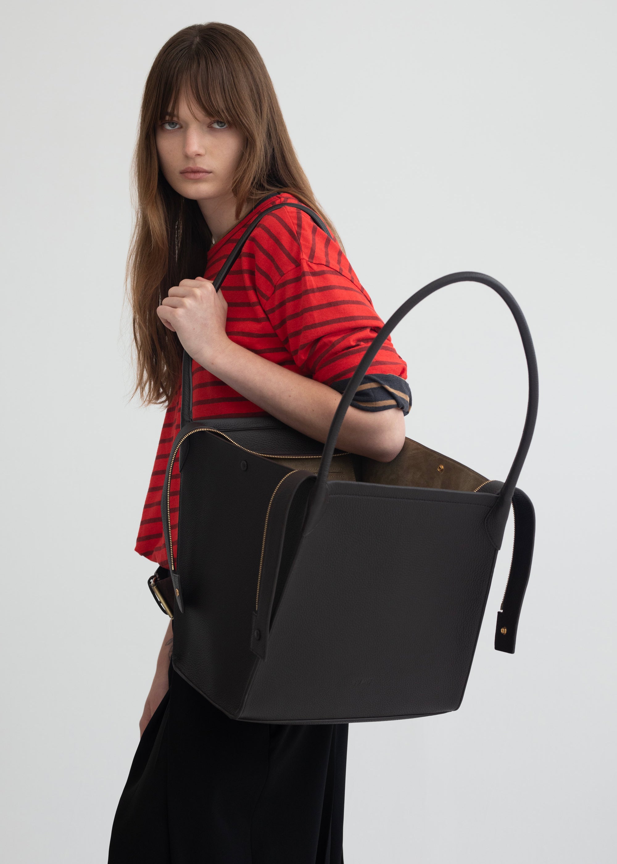 Claudia Tote in Americano Deer Nappa worn on the shoulder by model with tote shown open