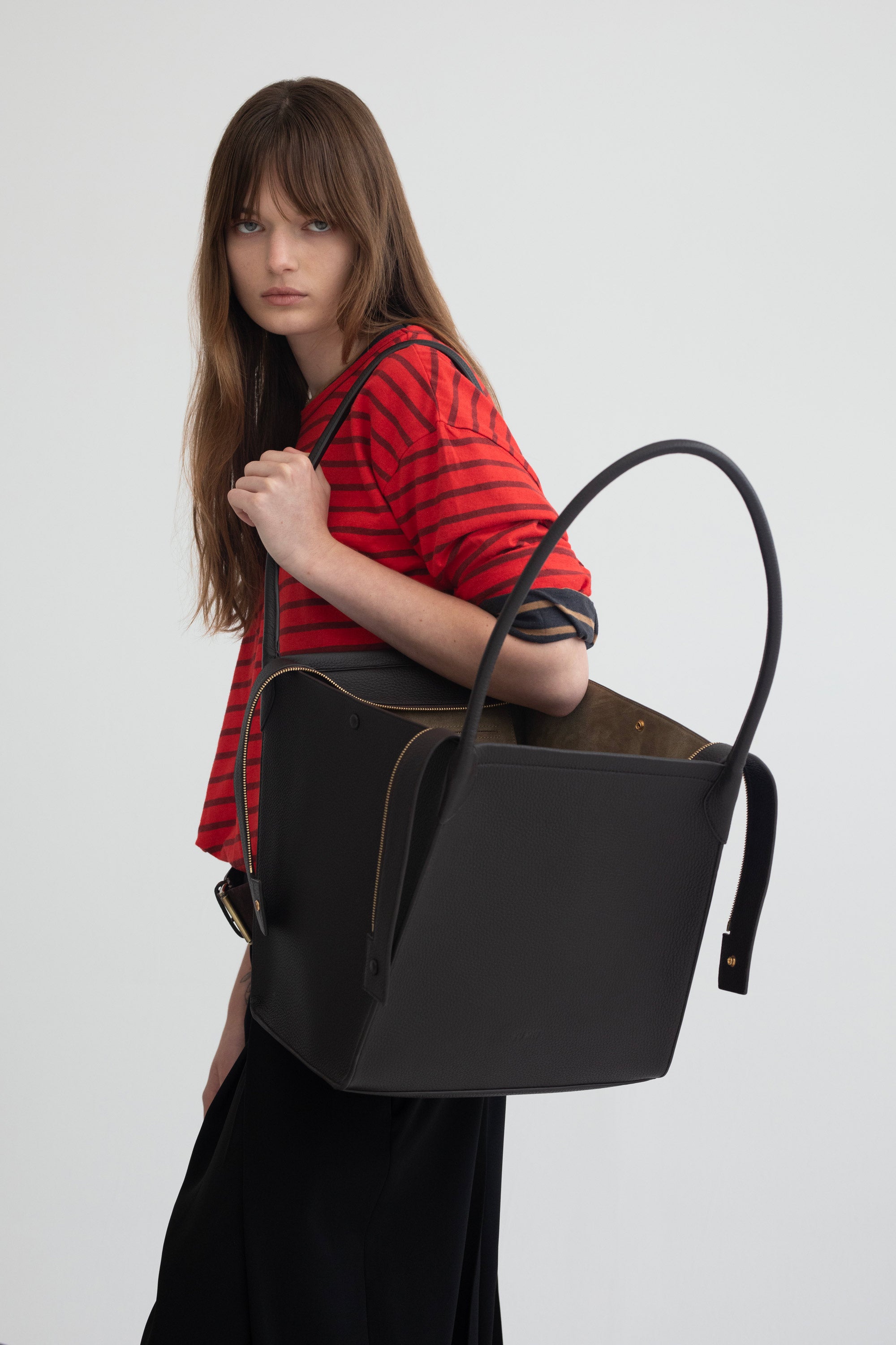 Claudia Tote in Americano Deer Nappa worn on the shoulder by model with tote shown open
