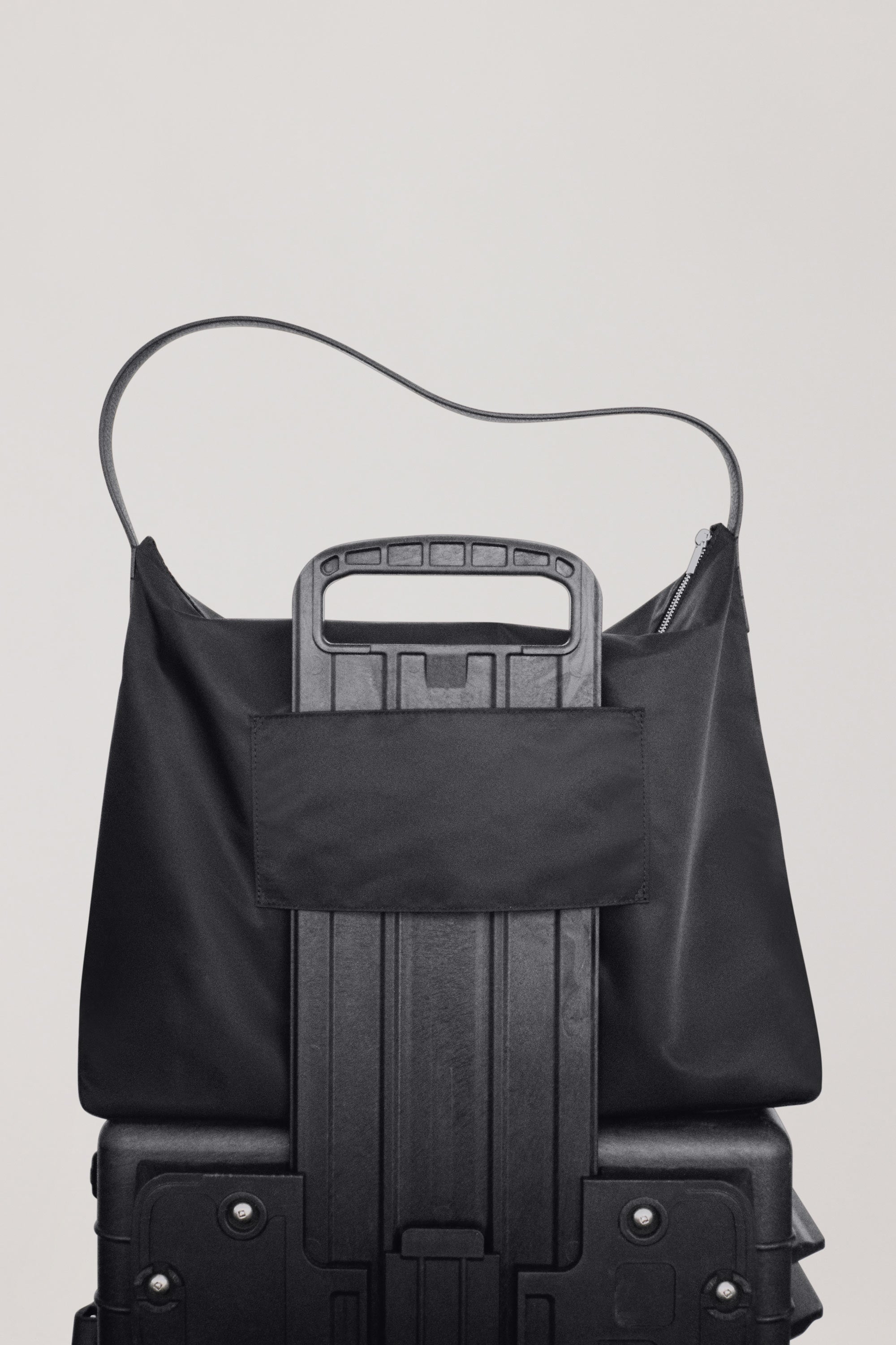 Large UTILITY Braidy in Black nylon back view showing external luggage slip over black suitcase handle