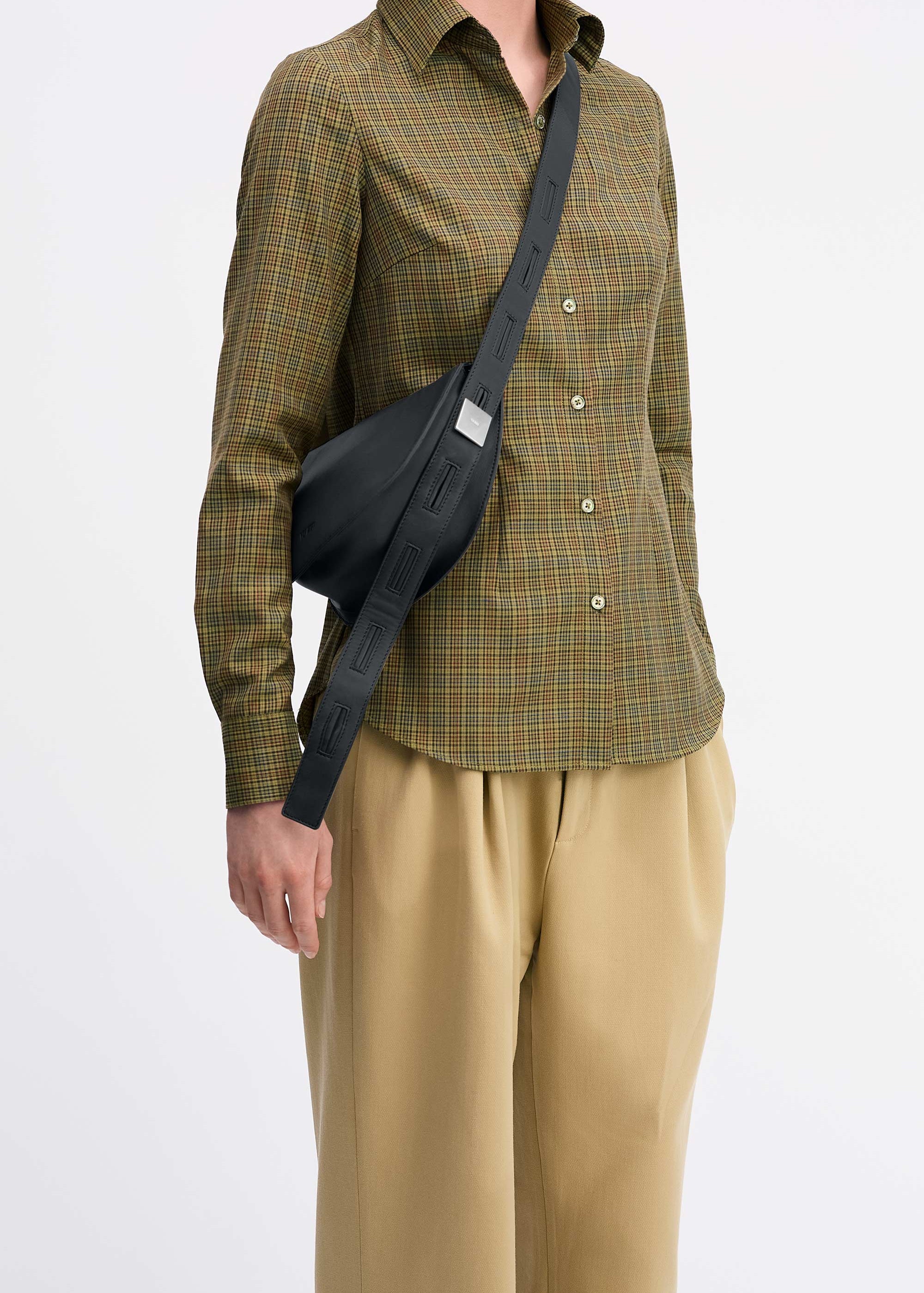 Mini Antonia Bag in Black Lambskin worn cross-body on model wearing check shirt and tan pants