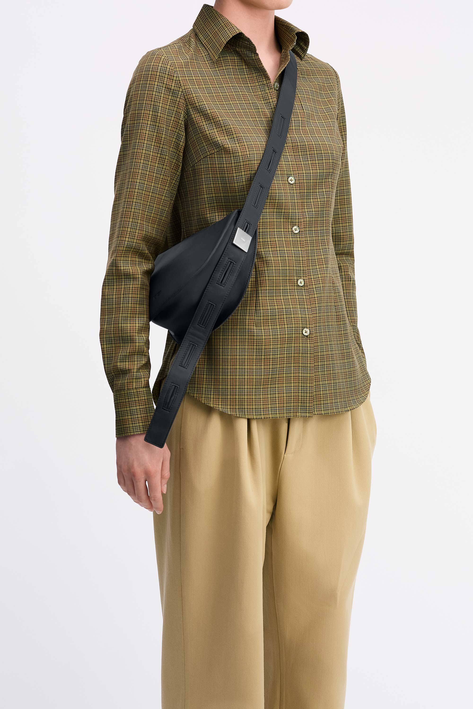 Mini Antonia Bag in Black Lambskin worn cross-body on model wearing check shirt and tan pants