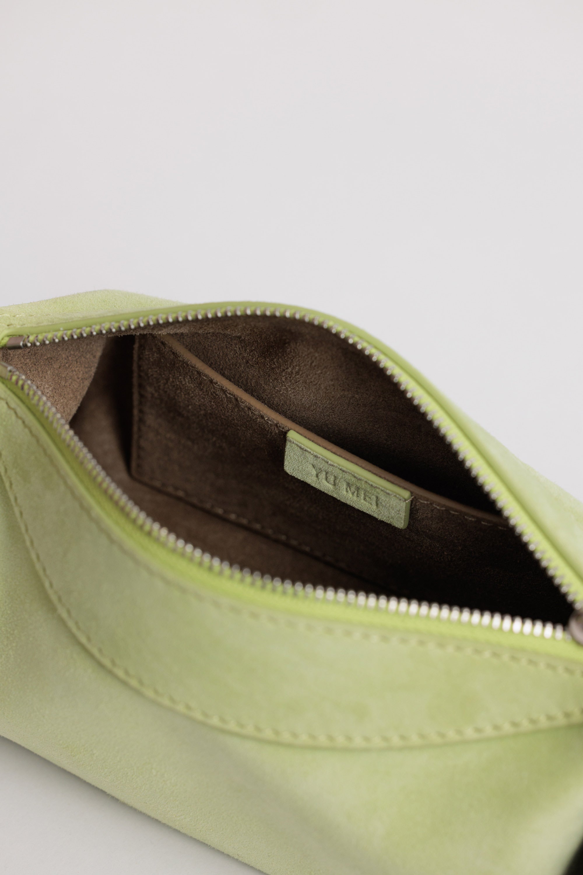 Yu Mei Mini Bobby in Apple Suede internal view showing small interior pocket and suede lining.
