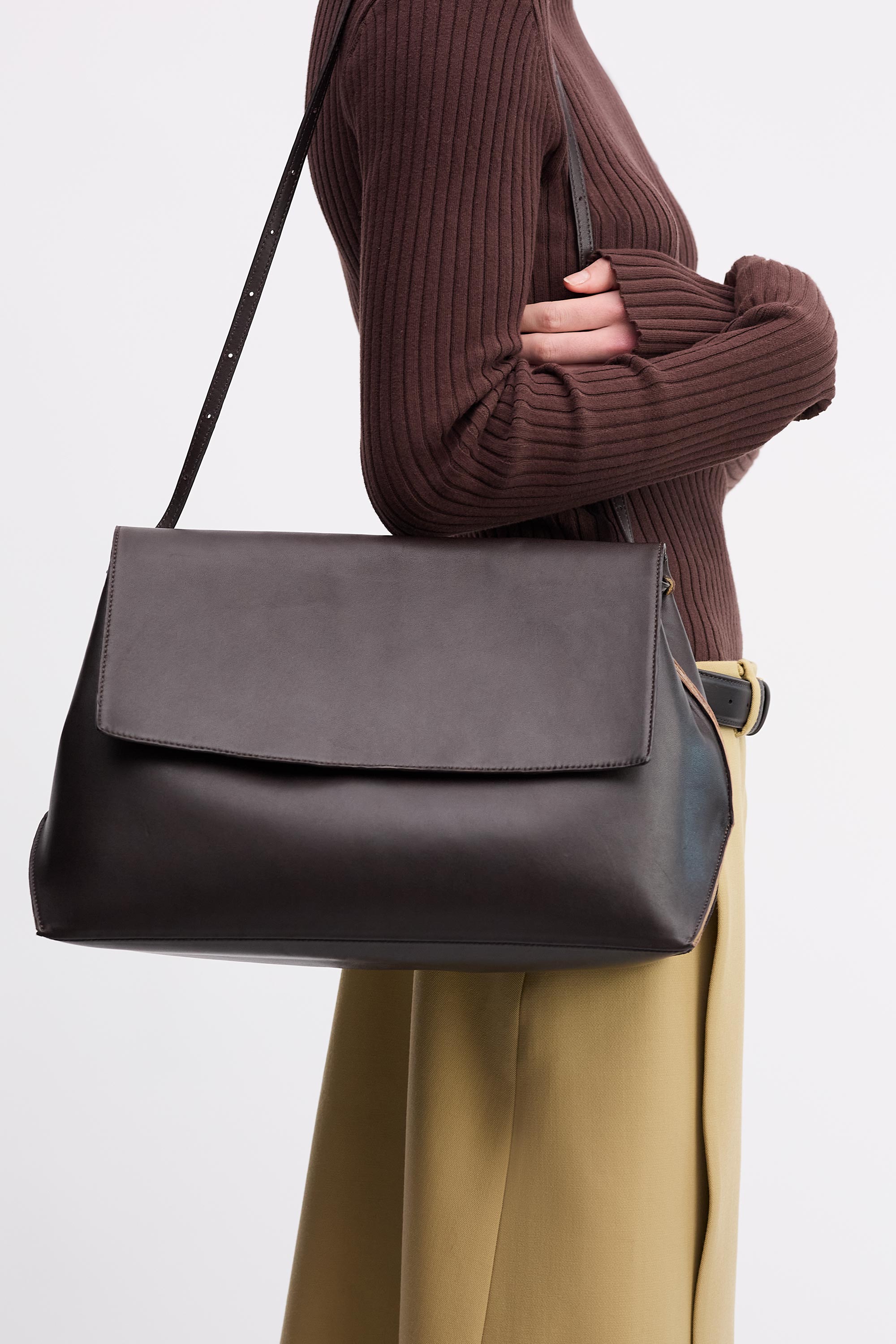 Pania Bag in Americano Lambskin worn on shoulder on model brown top and tan skirt with black belt side view