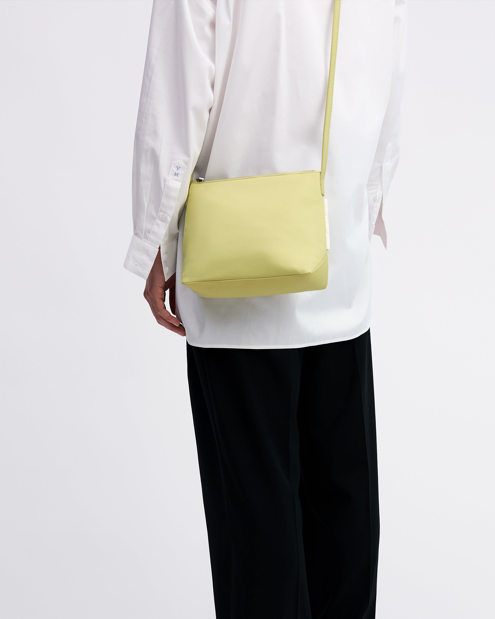 Yu Mei Small UTILITY Braidy in Half Green nylon side worn crossbody on model in white shirt and black trousers
