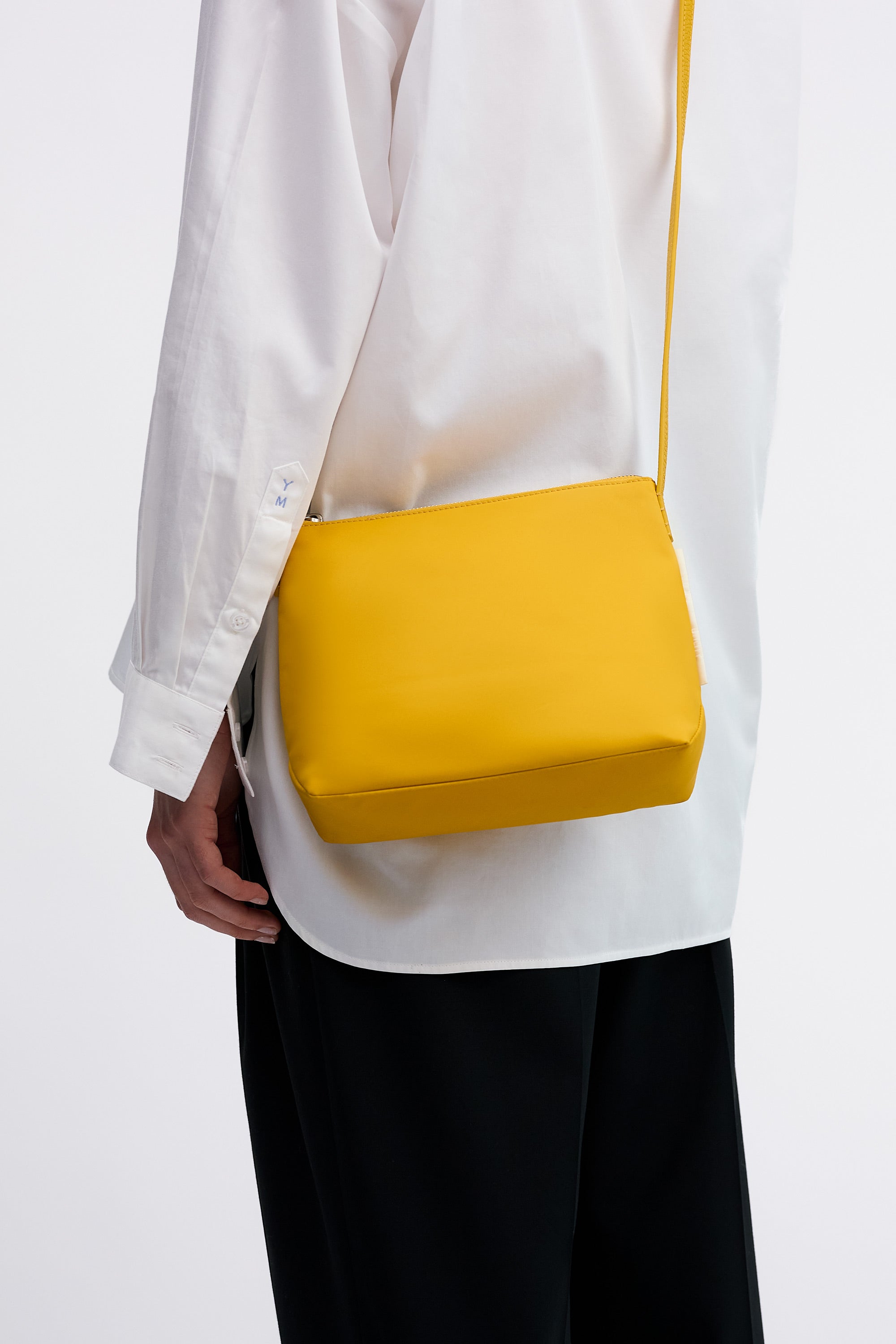 Yu Mei Small UTILITY Braidy in Honey nylon worn cross body on model wearing white shirt and black trousers