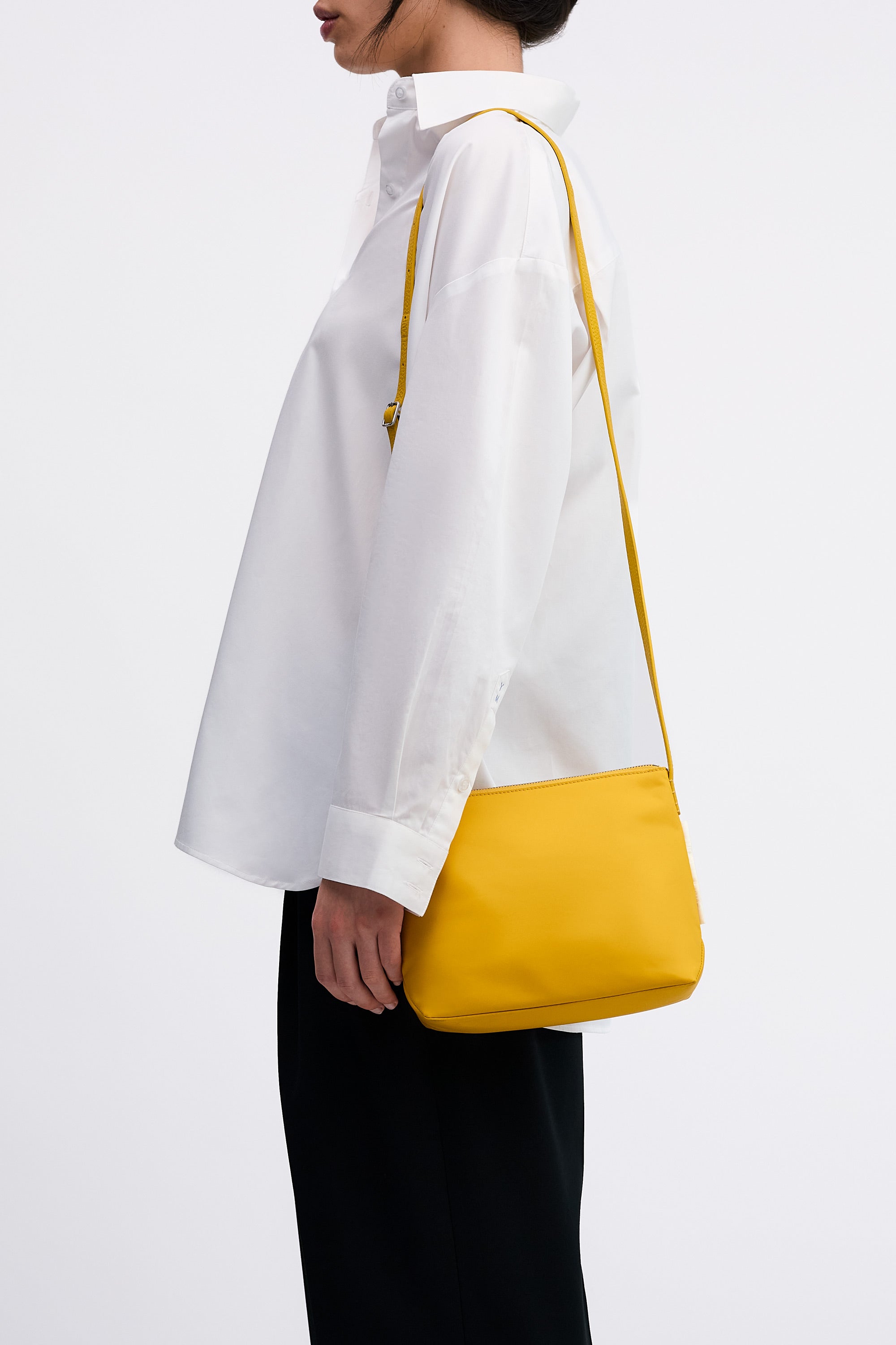 Yu Mei Small UTILITY Braidy in Honey nylon worn on shoulder of model wearing white shirt and black trousers