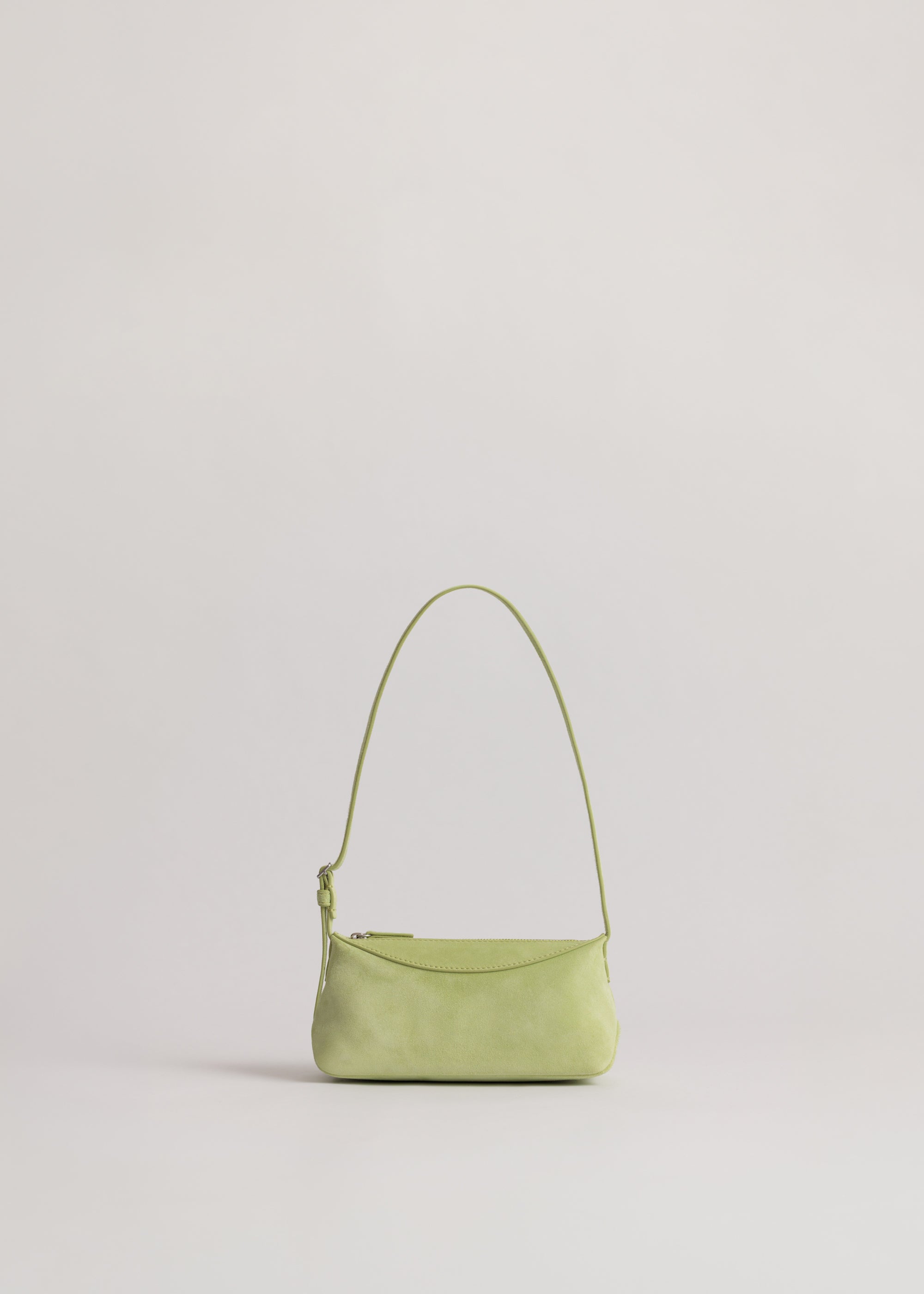Yu Mei Mini Bobby in Apple Suede front view showing feathered belt style adjustable strap.
