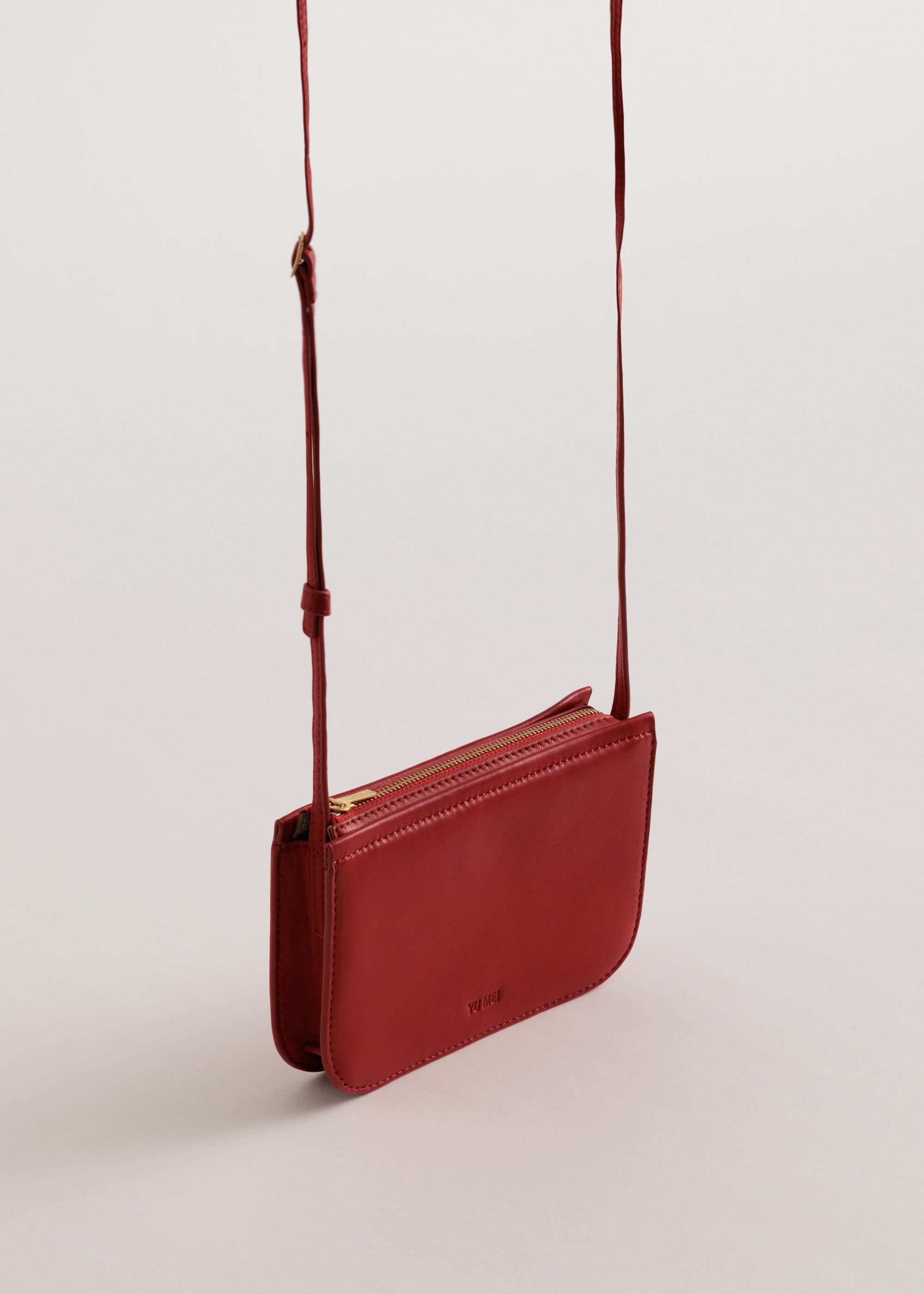 Vi Bag in Lobster Red Lambskin side view with crossbody strap