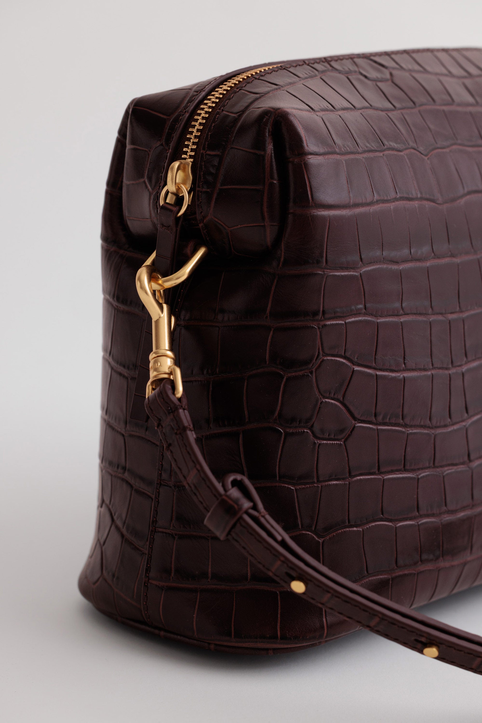 Close-up of leather grain on the Ch'lita Bag, showing natural texture and custom chrome hardware