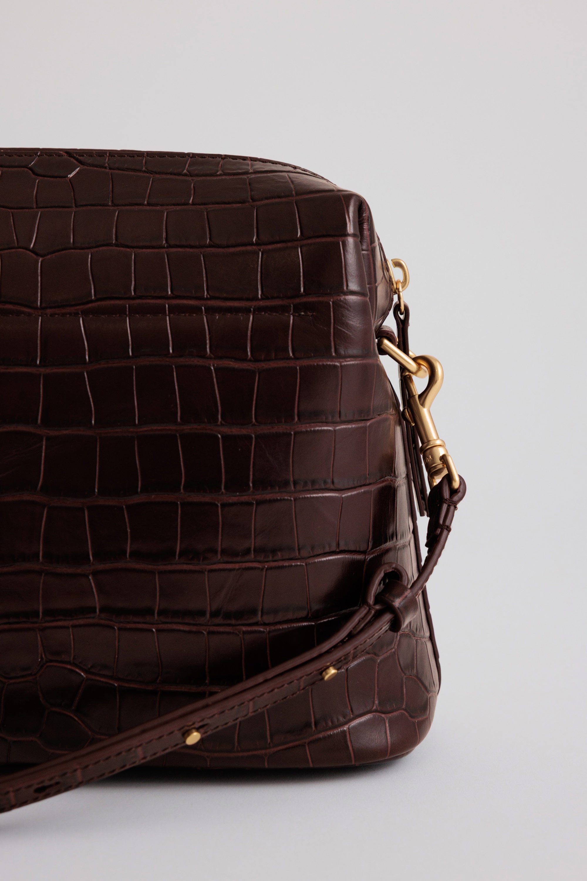 Close-up of leather grain on the Ch'lita Bag, showing natural texture and custom chrome hardware