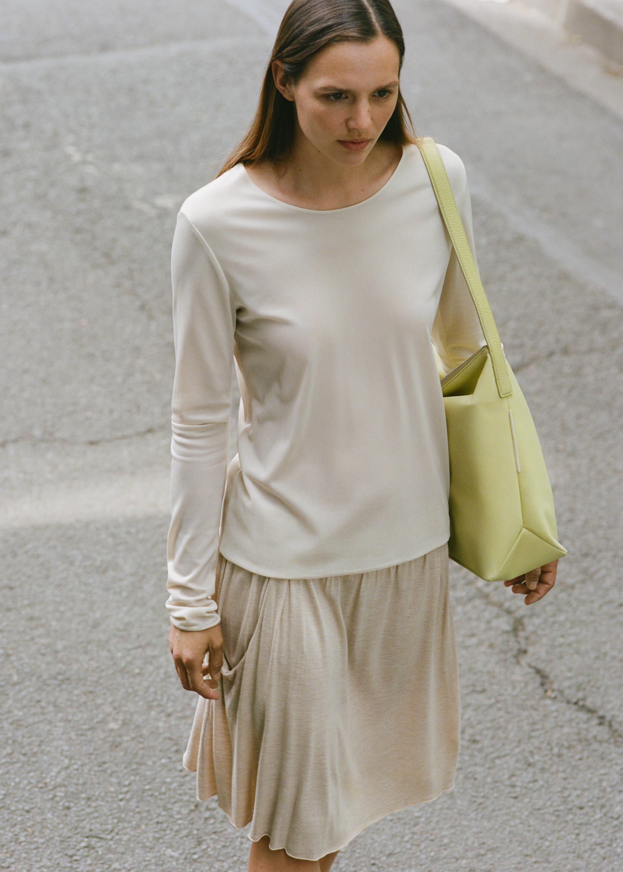 Model wearing the Medium UTILITY Braidy Bag in Half Green nylon on shoulder