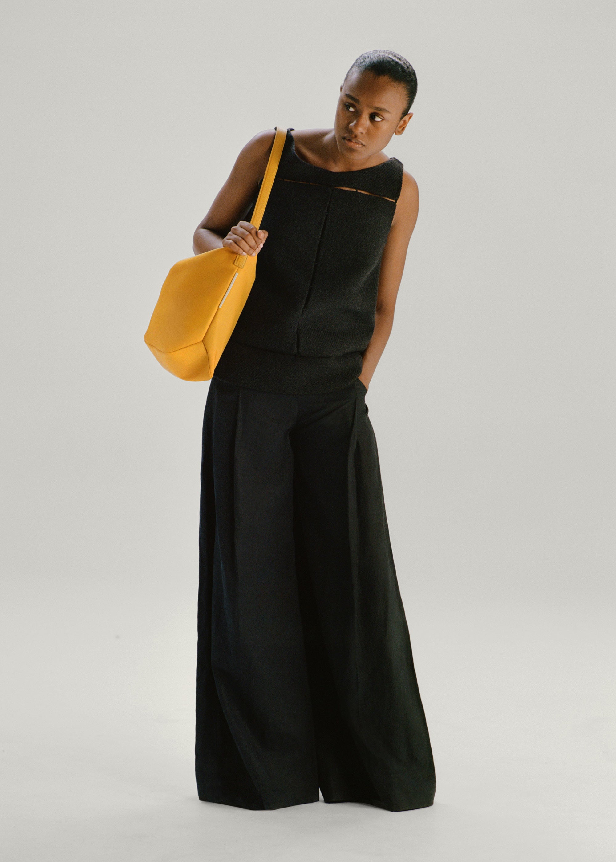 Model wearing the Medium UTILITY Braidy Bag in Honey nylon on shoulder
