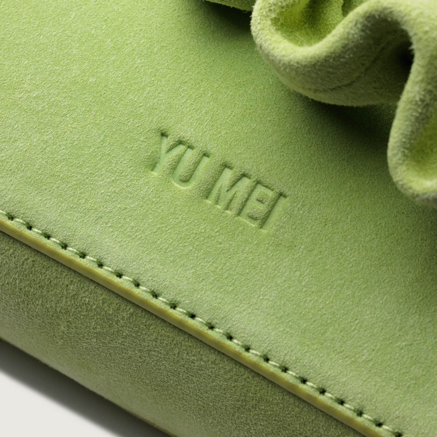 Minimal debossed Yu Mei logo